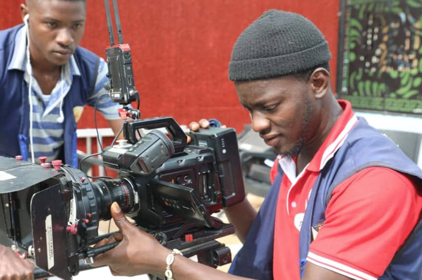 man holding film camera