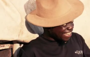 mechanic with cowboy hat smiling